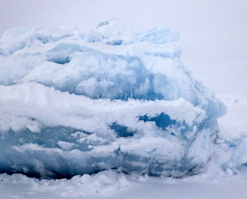 a big block of ice and a person with a sled